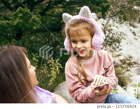 mother with daughter outside doing makeup having fun mother with daughter outside doing makeup having fun 125756924