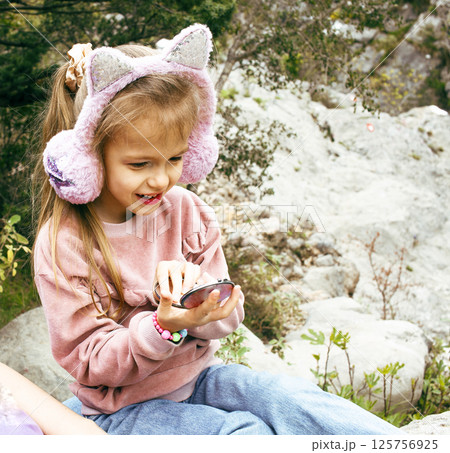 little cute girl with mirror outside playing having fun, lifestyle people concept little cute girl with mirror outside playing having fun, lifestyle people concept 125756925