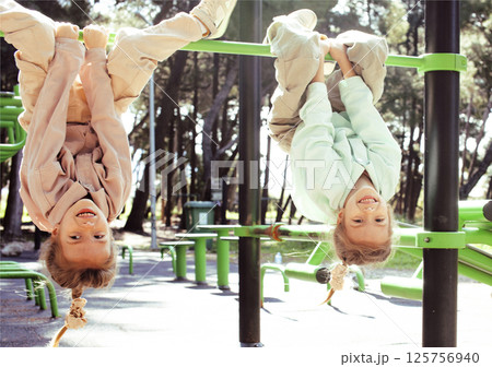 two pretty sisters twins playing outside, lifestyle people concept two pretty sisters twins playing outside, lifestyle people concept 125756940