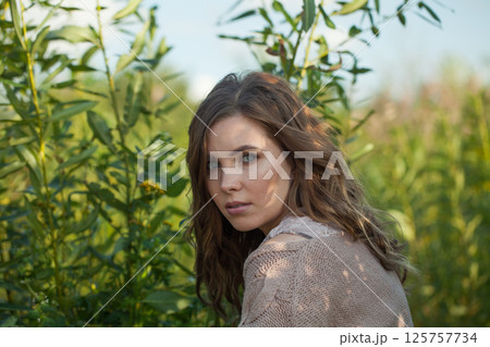 Cute spring woman walking outdoors on nature background, fashion beauty portrait Cute spring woman walking outdoors on nature background, fashion beauty portrait 125757734
