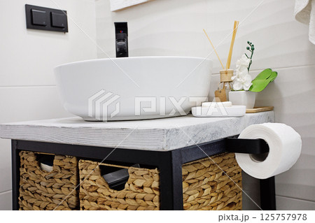 Modern and clean toilet, sink and toiletries 125757978