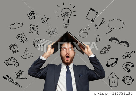 Emotional shocked businessman in suit with laptop on his head on grey background and icons: sport Emotional shocked businessman in suit with laptop on his head on grey background and icons: sport 125758130