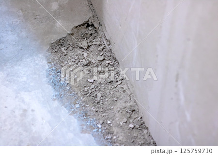 Closeup of a concrete surface with small rocks scattered 125759710