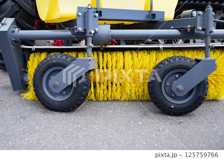 Close-up of industrial street sweeper brush and wheels. 125759766