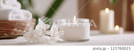 Spa concept with candle and white flowers, relaxing wellness background Spa concept with candle and white flowers, relaxing wellness background 125760023