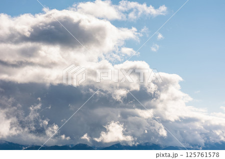heavy clouds on a blue sky above mountains september. dramatic view. early autumn cloudy weather over carpathian range. sunny morning heavy clouds on a blue sky above mountains september. dramatic view. early autumn cloudy weather over carpathian range. sunny morning 125761578
