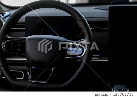 A close-up of a modern car's steering wheel with control buttons A close-up of a modern car's steering wheel with control buttons 125762719
