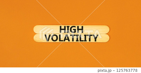High volatility symbol. Concept words High volatility on beautiful wooden stick. Beautiful orange table orange background. Business high volatility concept. Copy space. 125763778