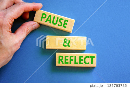 Pause and reflect symbol. Concept words Pause and reflect on beautiful block. Businessman's hand. Beautiful blue background. Business motivational lifestyle pause and reflect concept. Copy space. Pause and reflect symbol. Concept words Pause and reflect on beautiful block. Businessman's hand. Beautiful blue background. Business motivational lifestyle pause and reflect concept. Copy space. 125763786