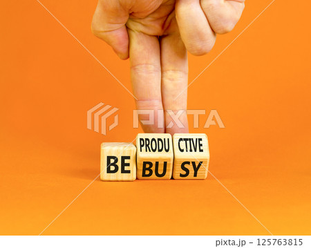 Be productive not busy symbol. Concept words Be productive Be busy on wooden block. Beautiful orange table orange background. Businessman hand. Business be productive not busy concept. Copy space. 125763815