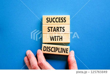 Success starts with discipline symbol. Concept words Success starts with discipline on beautiful wooden blocks. Beautiful blue background. Business success starts with discipline concept. Copy space 125763849