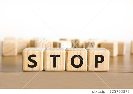 Stop symbol. Concept word Stop on beautiful wooden blocks. Beautiful wooden table white background. Business, lifestyle, support and stop concept. Copy space. 125763875