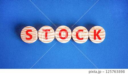Stock symbol. Concept word Stock on beautiful wooden circles. Beautiful blue table blue background. Business lifestyle stock concept. Copy space. Stock symbol. Concept word Stock on beautiful wooden circles. Beautiful blue table blue background. Business lifestyle stock concept. Copy space. 125763898