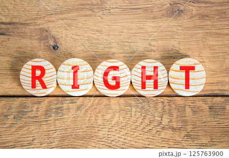 Right symbol. Concept word Right on beautiful wooden circles. Beautiful wooden table wooden background. Business lifestyle right concept. Copy space. Right symbol. Concept word Right on beautiful wooden circles. Beautiful wooden table wooden background. Business lifestyle right concept. Copy space. 125763900