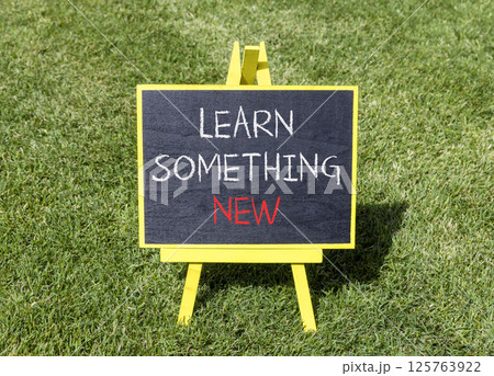 Learn something new symbol. Concept words Learn something new on beautiful yellow blackboard. Beautiful green grass background. Business motivational lifestyle learn something new concept. Copy space. Learn something new symbol. Concept words Learn something new on beautiful yellow blackboard. Beautiful green grass background. Business motivational lifestyle learn something new concept. Copy space. 125763922