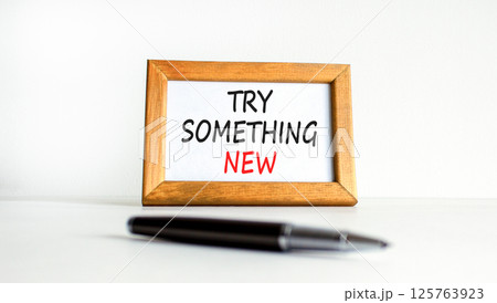 Try something new symbol. Concept words Try something new on beautiful wooden picture frame. Beautiful white background. Business motivational lifestyle try something new concept. Copy space. Try something new symbol. Concept words Try something new on beautiful wooden picture frame. Beautiful white background. Business motivational lifestyle try something new concept. Copy space. 125763923