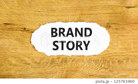 Brand story branding symbol. Concept words Brand story on beautiful white paper. Beautiful wooden background. Business brand story branding concept. Copy space. 125763960
