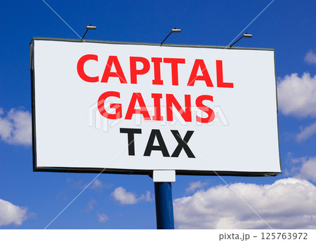 Capital gains tax symbol. Concept words Capital gains tax on beautiful big white billboard. Beautiful blue sky clouds background. Business and capital gains tax concept. Copy space. 125763972