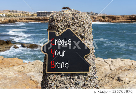 CYB Create your brand symbol. Concept words CYB Create your brand on beautiful yellow blackboard. Beautiful stone blue sky sea background. Business CYB Create your brand concept. Copy space. CYB Create your brand symbol. Concept words CYB Create your brand on beautiful yellow blackboard. Beautiful stone blue sky sea background. Business CYB Create your brand concept. Copy space. 125763976