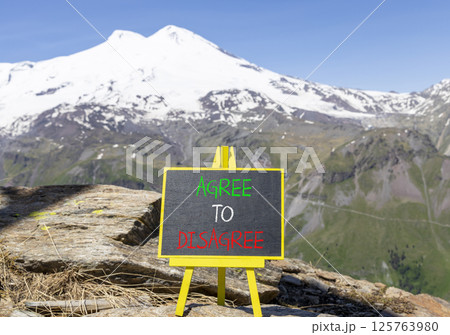 Agree to disagree symbol. Concept words Agree to disagree on beautiful blackboard. Beautiful mountain Elbrus background. Business and agree to disagree concept. Copy space. 125763980
