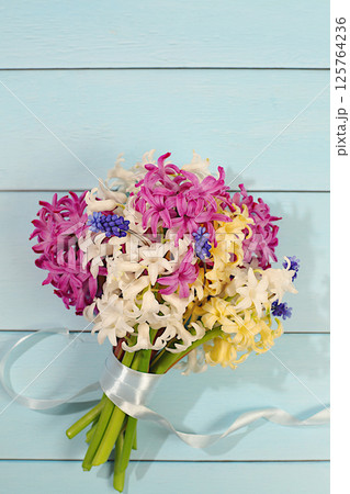 Beautiful bouquet of different varieties of hyacinths and muscari. Abstract flower arrangement for screen and design template. Spring card, business card for product display, gift for loved ones. Beautiful bouquet of different varieties of hyacinths and muscari. Abstract flower arrangement for screen and design template. Spring card, business card for product display, gift for loved ones. 125764236