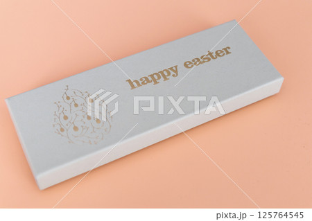 A box of chocolate eggs with the inscription in English Happy Easter.  125764545