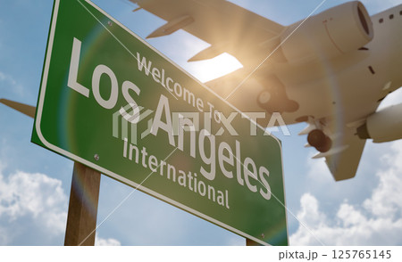 Welcome to Los Angeles International Airport Green Road Sign with Airplane Above. 125765145