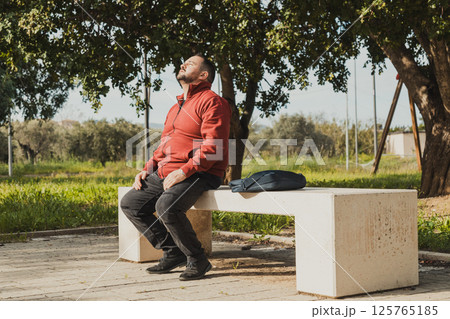 Worker Sitting To Start The Job At The Park Worker Sitting To Start The Job At The Park 125765185