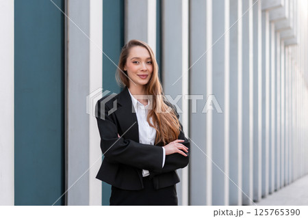Portrait of smiling woman in business suit Portrait of smiling woman in business suit 125765390