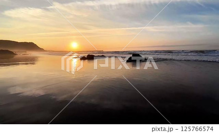 Witness the breathtaking beauty of a stunning sunset at the tranquil, serene beachside 125766574