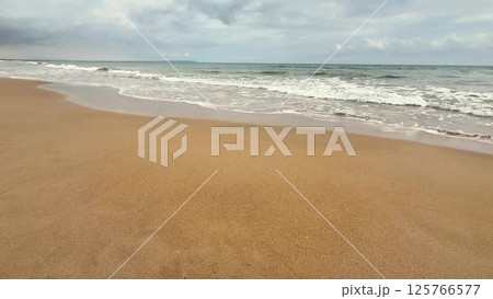 A Serene and Picturesque Beach Scene Featuring Gentle Waves and a Beautiful Sandy Shore 125766577
