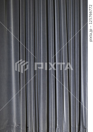 Blue Velvet Curtain with Pleats in a Vertical Fold Pattern 125766772