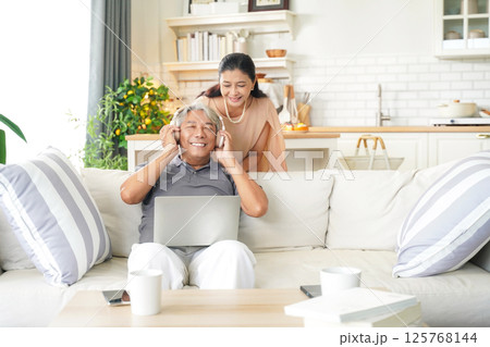 Asia happy senior elderly couple hugging and embrace at living room. Se Asia happy senior elderly couple hugging and embrace at living room. Se 125768144