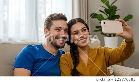 Happy Couple Taking Selfie on Sofa Happy Couple Taking Selfie on Sofa 125770593