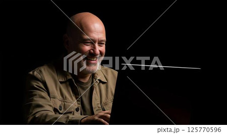 Happy Mature Man Using Laptop at Night 125770596