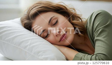 Woman sleeping peacefully in bed Woman sleeping peacefully in bed 125770610