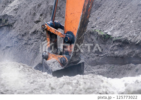 Excavator bulldozer bucket digging a hole, trench.Loading bulk 125773022