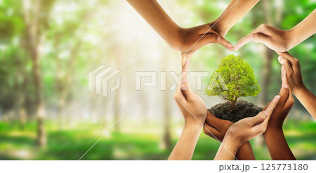 Earth day and earthday as group of diverse people joining to form heart hands connected together protecting the environment and promoting conservation and climate change issues as an image. 125773180