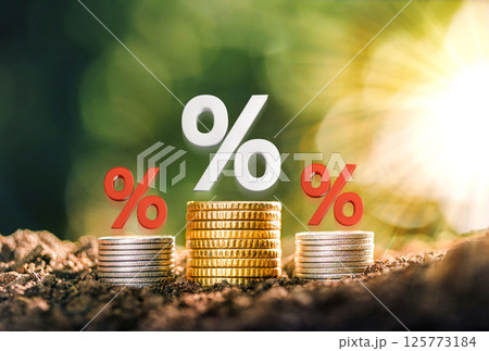 Mortgage rates A pile of coins placed on the table together with interest rate illustrations. planning savings money of coins to buy a home concept for property, mortgage, real estate. 125773184