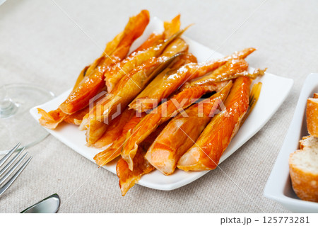 Cold smoked salmon belly strips 125773281