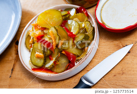 Pickled bell peppers and cucumbers in glass jar 125773514