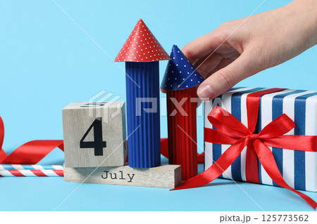 Paper fireworks with a gift on a blue background 125773562