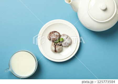 Appetizing crinkle cookies, on a blue background. Appetizing crinkle cookies, on a blue background. 125773584