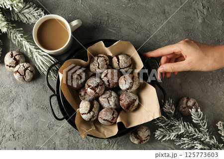 Delicious crinkle cookies in a plate, on a dark background. Delicious crinkle cookies in a plate, on a dark background. 125773603