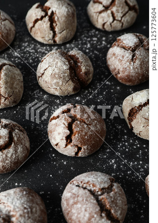 Delicious grinkle cookies on a black, stone board. 125773604