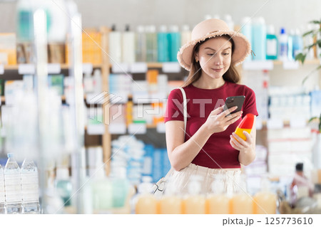 Young woman scanning qr code of repellent 125773610