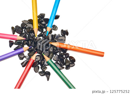 Colored pencils on black stones on white.Inspired,drawing,art Colored pencils on black stones on white.Inspired,drawing,art 125775252