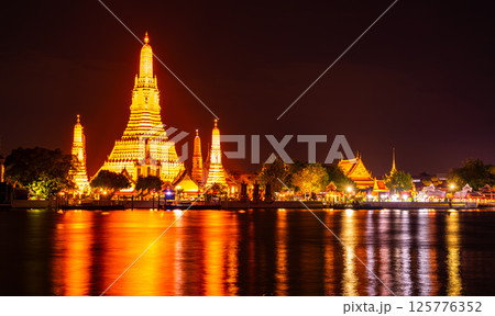 Wat Arun Ratchawararam Ratchawaramahawihan or Wat Arun, Buddhist temple along the Chao Phraya river at night sky in Bangkok, Thailand 125776352