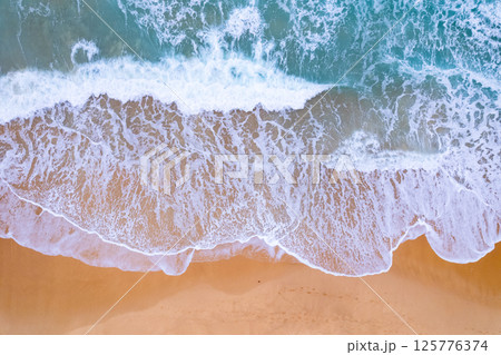 Amazing Top view sea beach landscape background,Summer sea waves crashing on sandy shore seascape background,High angle view ocean nature background 125776374