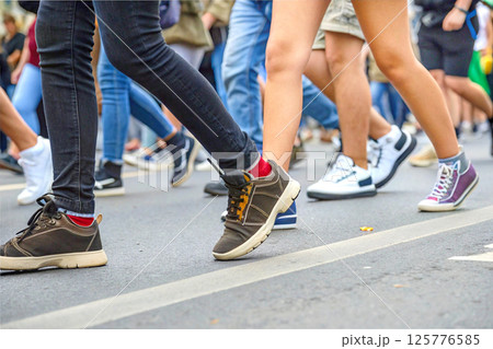 Human legs of people hurrying about their business and needs 125776585